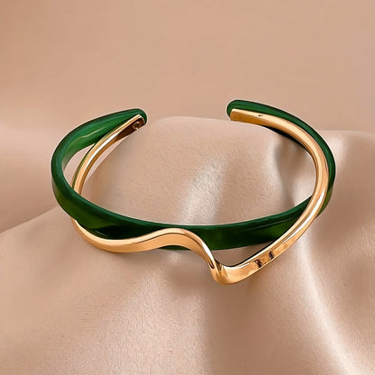 Stijve golfvormige armband verguld met 18K goud