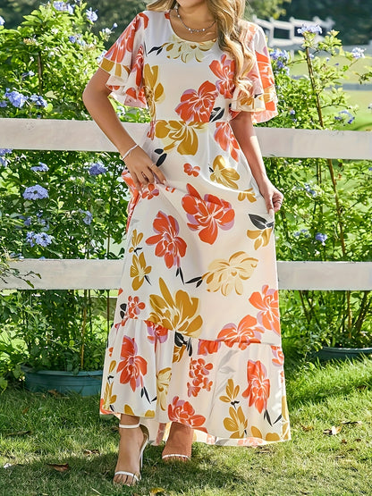 Lange jurk met grote bloemen in warme oranje en gouden tinten