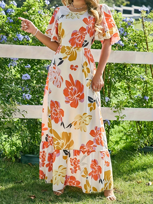 Lange jurk met grote bloemen in warme oranje en gouden tinten