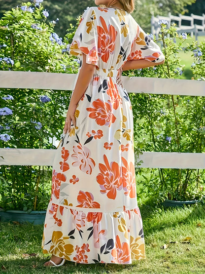 Lange jurk met grote bloemen in warme oranje en gouden tinten